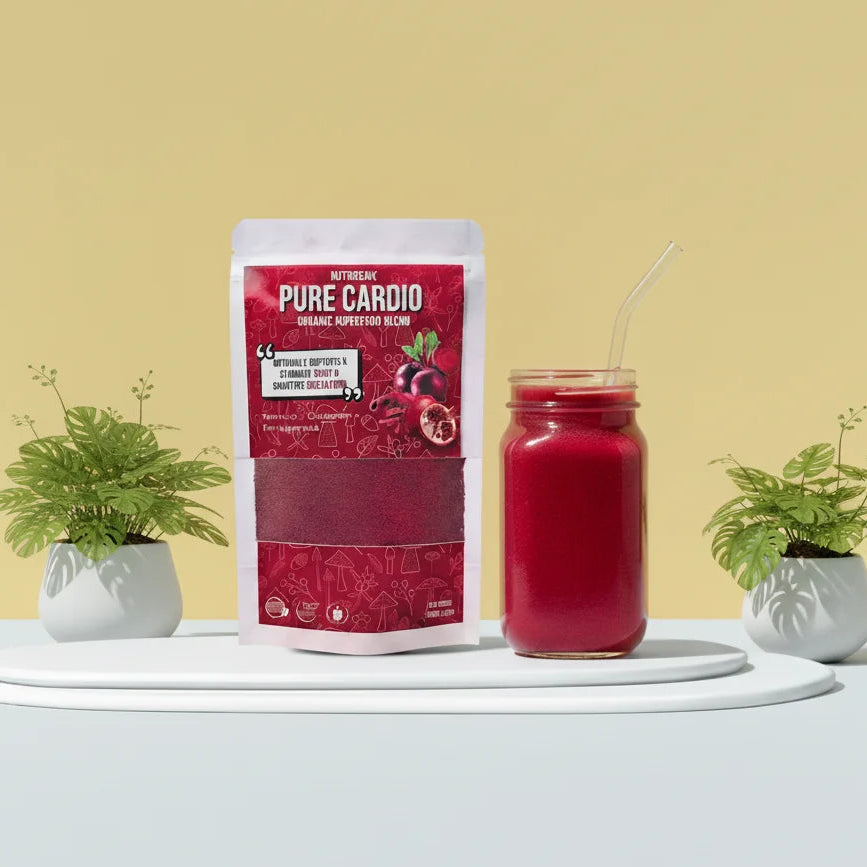 Red supplement package labeled 'Pure Cardio' next to a glass of red juice of beetroot, pomegranate and cinnamon on a white surface with a yellow background.